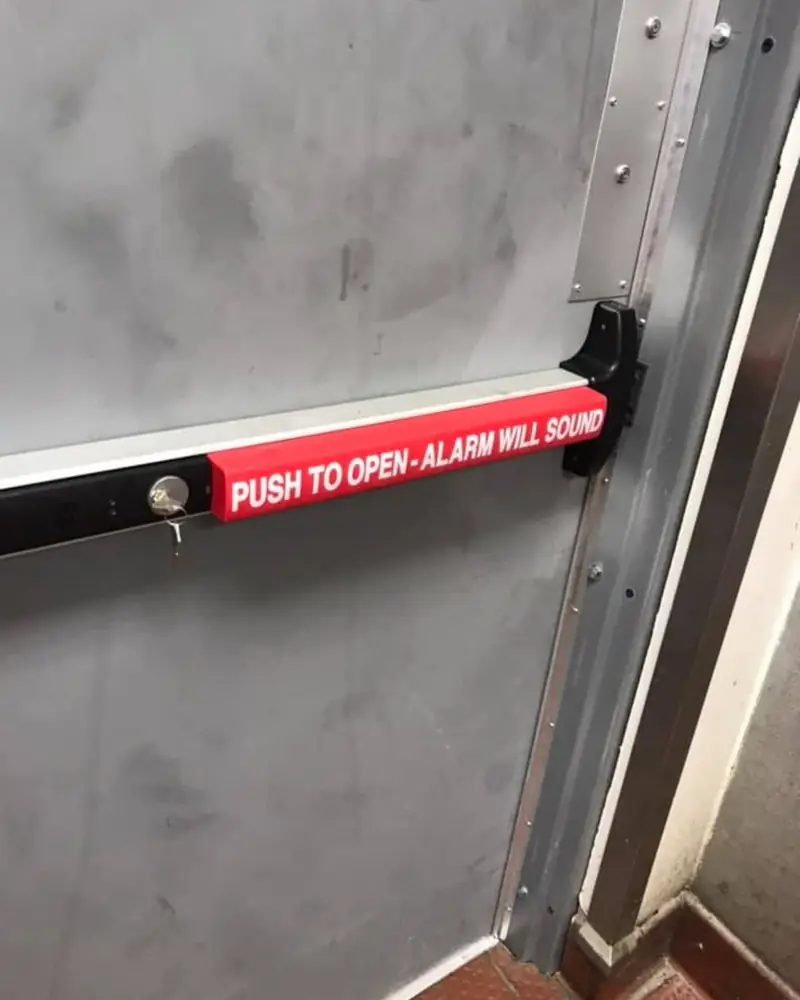 Panic-bar exit hardware on a commercial steel door