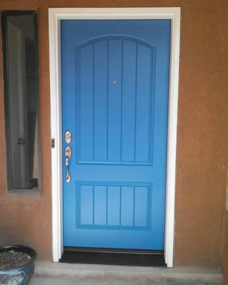 Blue entry door on stucco