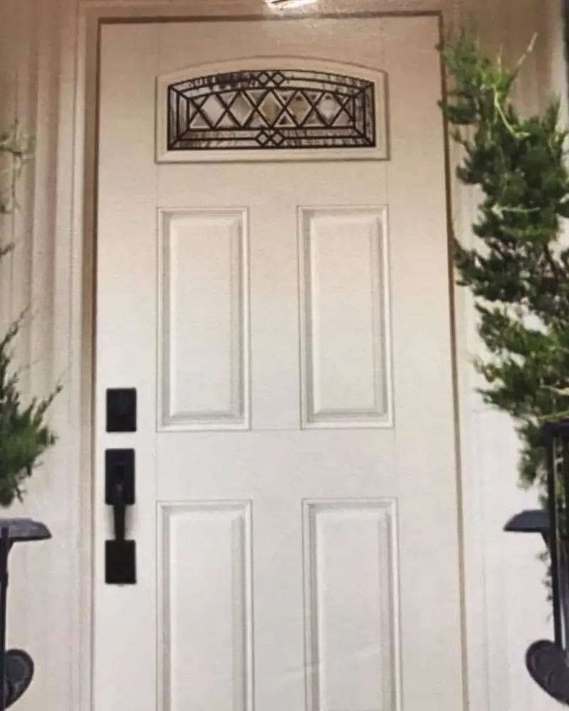 Six-panel entry door with an iron transom